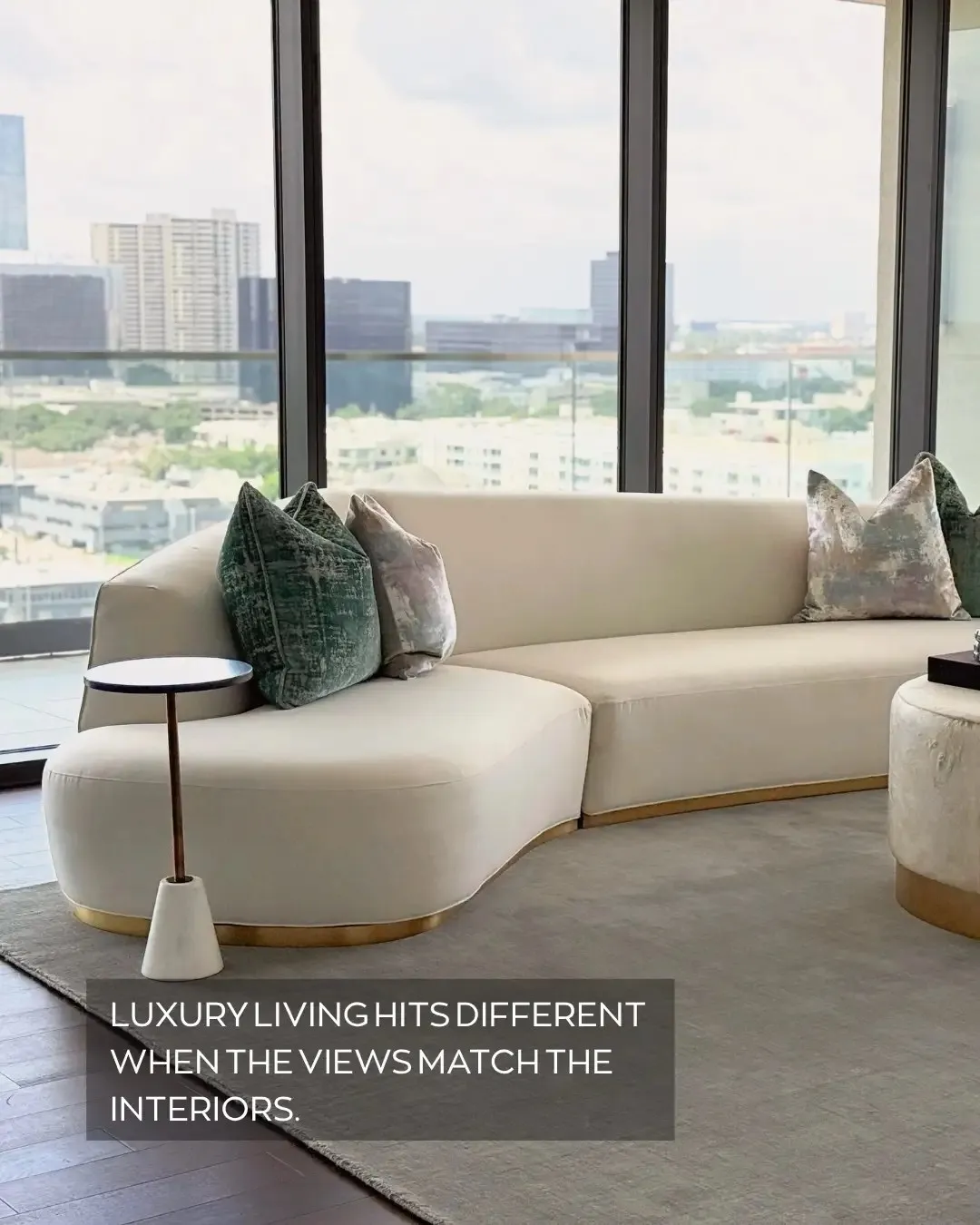 Luxe Design Group post: a curved sofa facing floor-to-ceiling city views, captioned “Luxury living hits different when the views match the interiors.”